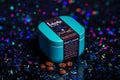 Blue Starlight Editions tin with coffee beans on a dark, glittery background