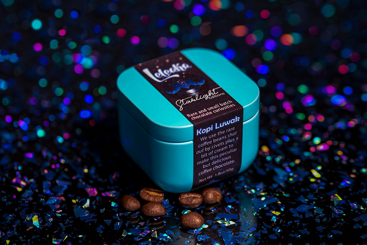 Blue Starlight Editions tin with coffee beans on a dark, glittery background